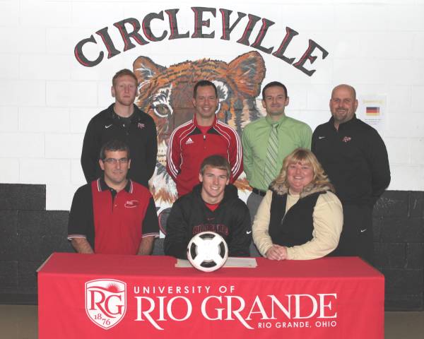 Circleville High School's Kevin McCrady is surrounded by family and coaches after signing to play soccer at Rio Grande